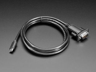 Angled shot of a coiled cable with USB-C and DB-9 connectors.