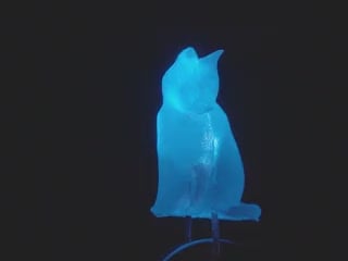 Close-up video of a cat-shaped LED rotating to show all the sides and details. The LED glows blue light.