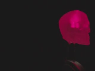 Close-up video of a skull-shaped LED rotating to show all the sides and details. The LED glows red light.