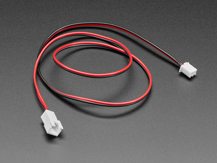 Angled shot of a semi-coiled half-meter long JST-XH extension cable in red and black.