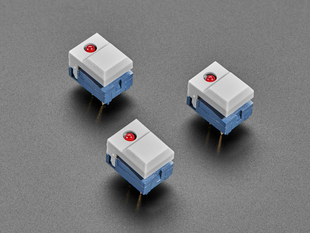 Angled shot of three gray plastic step switches with LED.