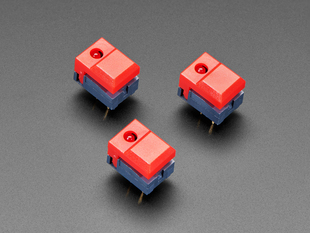 Angled shot of three red plastic step-switches with red LEDs.