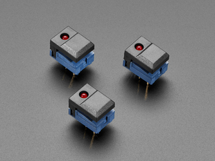 Angled shot of three black plastic step-switches with red LEDs.