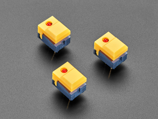 Angled shot of three yellow step-switches with LEDs.