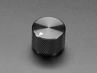 Angled shot of a black aluminum knob. A white triangle on top of the knob points at 5:00. 