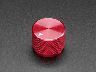 Angled shot of a red aluminum knob. A white triangle on top of the knob points at 7:00. 