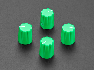 Angled shot of four green plastic micro knobs.
