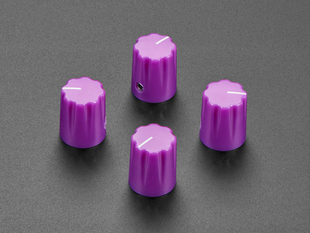 Angled shot of  four violet-purple plastic micro knobs.