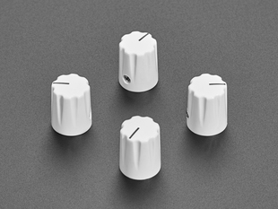 Angled shot of four white micro knobs.