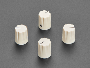 Angled shot of four cream micro knobs.