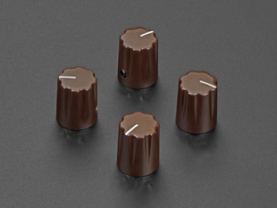 Angled shot of four brown plastic micro knobs.