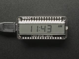Overhead video of an assembled monochrome LCD screen breakout displaying the time 11:43 A.M.