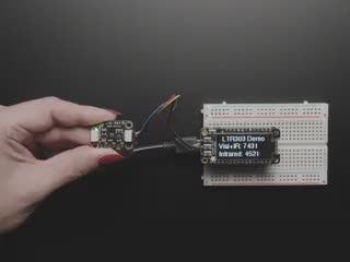 Overhead video of a light sensor connected to an OLED screen breakout, which displays infrared and visibility data.