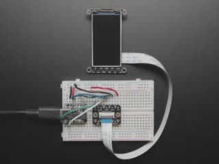 Overhead video of a 1.9" TFT display connected via 18-pin FPC ribbon cable to a square-shaped microcontroller on a breadboard. The TFT plays an animated boot-up demo.