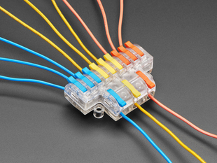 Angled shot of 3-to-9 Wiring Block Connector assembled with blue, yellow, and red wires.