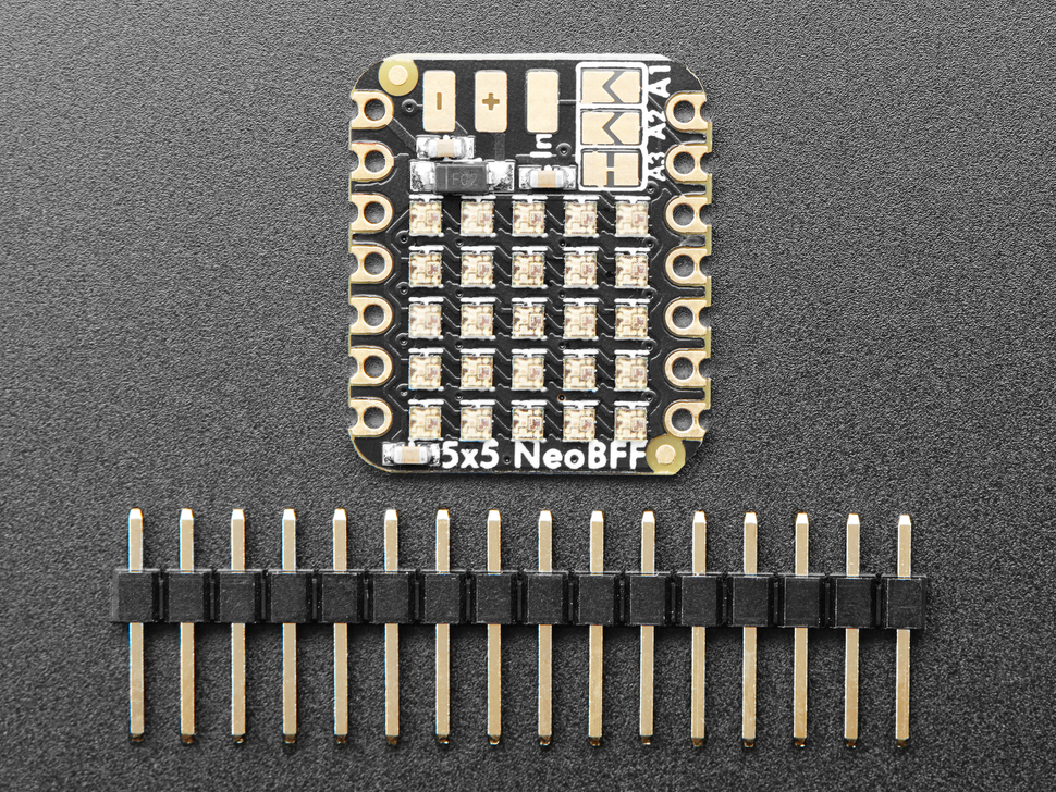 Overhead shot of small driver board with 5x5 addressable LEDs above a piece of 16-pin header.