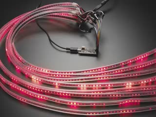 Angled video of eight LED strips fanned like a curtain emitting rainbow colors.