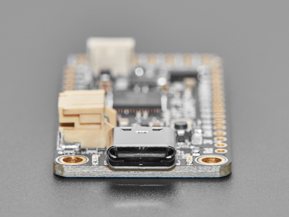 Close-up of USB-C connector on rectangular microcontroller.