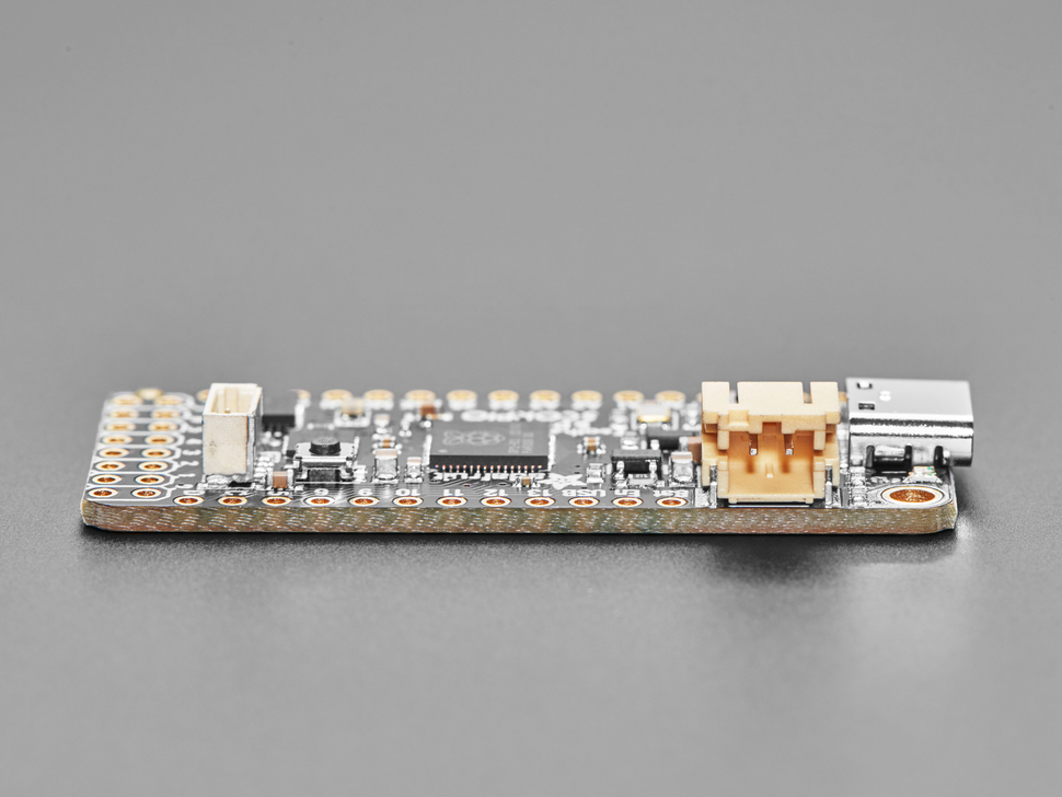Close-up of tan 2-pin JST-PH connector on rectangular microcontroller.