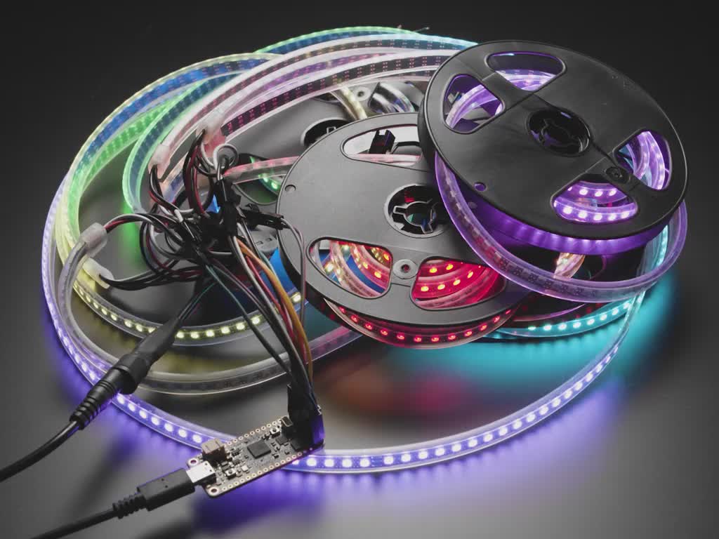 Video of eight LED strips in reels flashing rainbow colors.