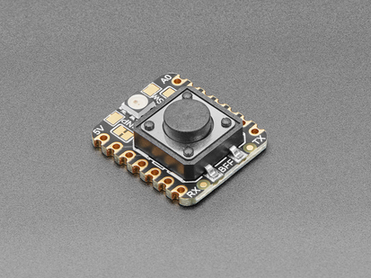 Angled shot of a square-shaped breakout board with an on-off button.