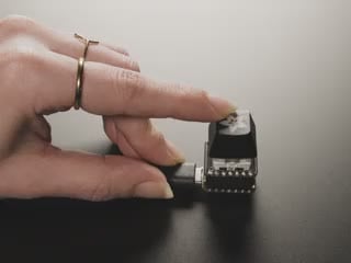 Video of a white finger pressing a mechanical key switch on a breakout board. The RGB LED emits rainbow colors whenever the finger presses the key switch.