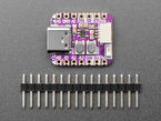 purple, square-shaped microcontroller above a piece of 16-pin header.
