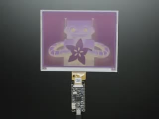 Overhead video of a rectangular microcontroller powering a big e-ink display.