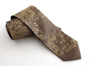Close up of olive colored tie with gold circuit board imagery 