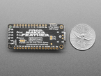 Back of "Prop-Maker Feather" PCB next to US quarter for scale.