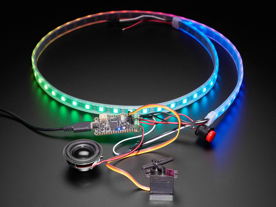 Photo wired up to the microcontroller are a servo motor and a speaker with a LED lighting of colors. 