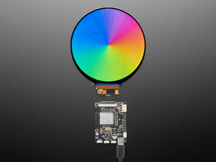 Overhead shot of round TFT display with a color gradient rainbow image.