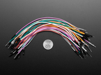 Top Down Shot of Premium Silicone Covered Extension Jumper Wires next to U.S. Quarter for Scale