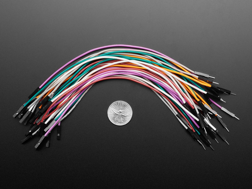 Top Down Shot of Premium Silicone Covered Extension Jumper Wires next to U.S. Quarter for Scale