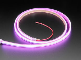 Angled shot of coiled LED strip lighting up pink light.