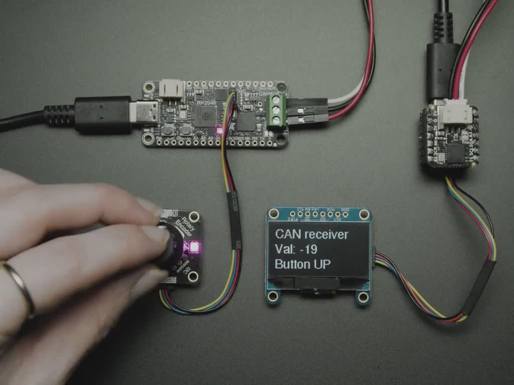 Video of a hand turning a rotary encoder with data readout on an OLED screen.