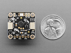 Top Down Back Shot of the I2C Stemma QT Rotary Encoder Breakout with Encoder next to U.S. Quarter for Scale.