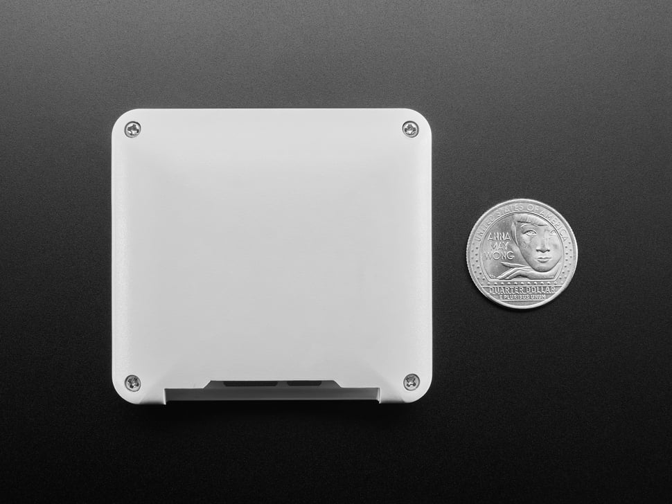 Back of white, square-shaped display module next to US quarter for scale.
