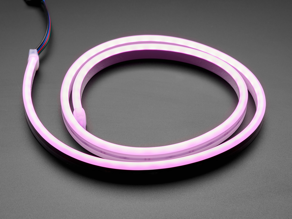 Angled shot of coiled LED strip lighting up pink.