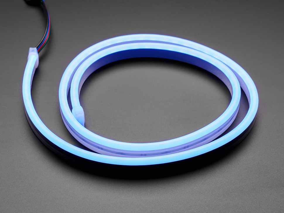Angled shot of coiled LED strip lighting up blue.