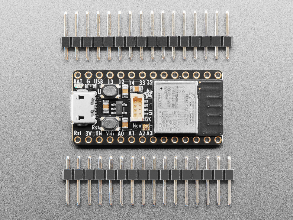 black, rectangular microcontroller between two pieces of 16-pin header.