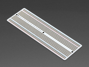 Angled shot of Adafruit Perma-Proto Full-sized Breadboard PCB.