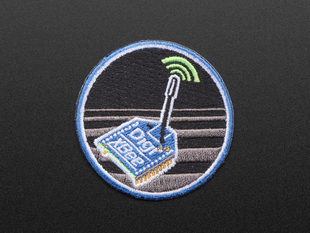 Circular embroidered badge with DIGIXBEE box in blue over a black and grey striped background, with blue trim. 