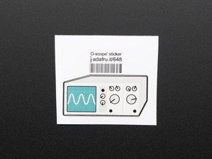 Sticker in the shape of analog oscilloscope in grey with turquoise screen showing sine wave. Mounted on white paper with barcode. 