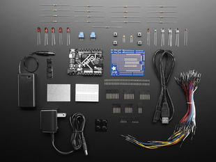 Adafruit Metro 328 Starter Pack showing kit contents, with boards, PCBs, wires and power supplies