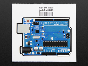 Rectangularish sticker in the shape of arduino uno, in light blue with grey edging and ICU and component details in black and grey. Mounted on white paper with barcode. 