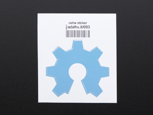 Light blue sticker in the shape of partial gear open source hardware logo. Mounted on white paper with barcode. 