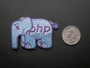 Embroidered badge in the shape of the php elephant logo. Light blue with the letters PHP and outlines in purple. Next to a quarter for scale. 