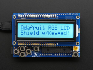 RGB LCD Shield Kit w/ 16x2 Character Display. Display backlight blue and reads "Adafruit RGB LCD Shield w/Keypad!"