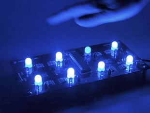 Hand waving over 2x4 blue LED grid